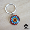 Keychain ring showcasing a vibrant Flower Mandala design inside of a magnifying glass cabochon. – Chakvana.com