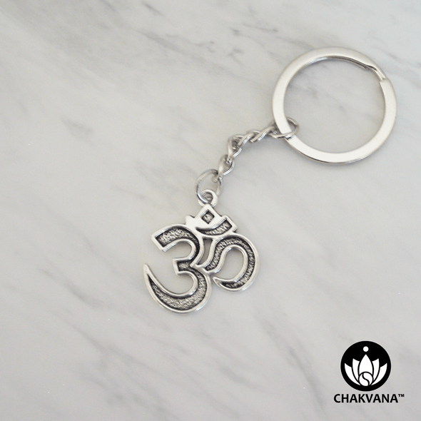 Silver metal alloy keychain featuring a sacred Om symbol. – Chakvana.com