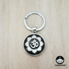 Keychain ring displaying an Om & Lotus Petal design inside of a magnifying glass cabochon.  – Chakvana.com
