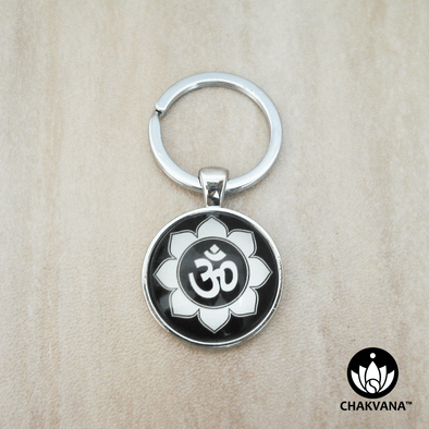 Keychain ring displaying an Om & Lotus Petal design inside of a magnifying glass cabochon.  – Chakvana.com