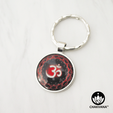 Keychain with a sacred Om symbol centered amongst two layers of red lotus petals. – Chakvana.com