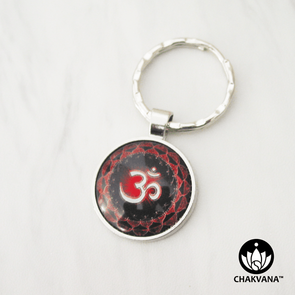 Keychain with a sacred Om symbol centered amongst two layers of red lotus petals. – Chakvana.com