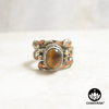 Ring with polished Tiger's Eye oval gemstone and decorative braided multi-metal ring band. – Chakvana.com